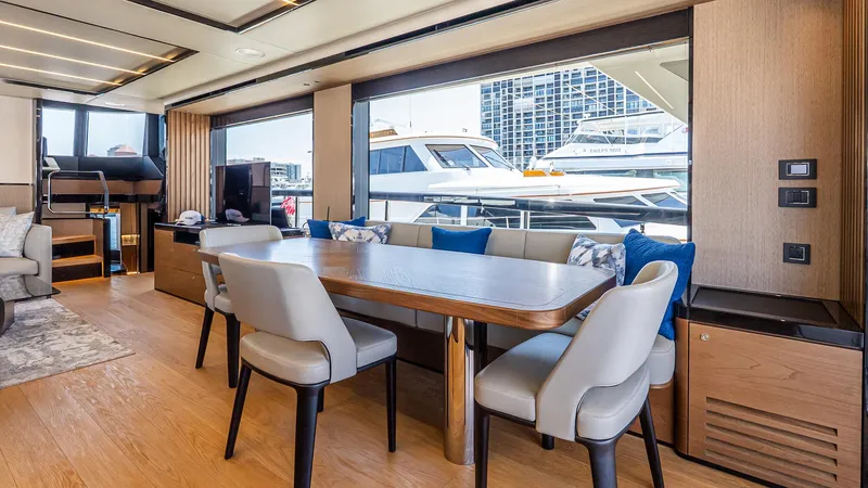Available Now Yacht Photos Pics Luxurious interior of 2024 Absolute 68 NAVETTA yacht with elegant dining area and marina view.