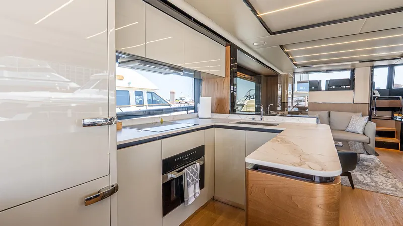 Available Now Yacht Photos Pics Luxurious interior of 2024 Absolute 68 NAVETTA yacht featuring modern kitchen and seating area.
