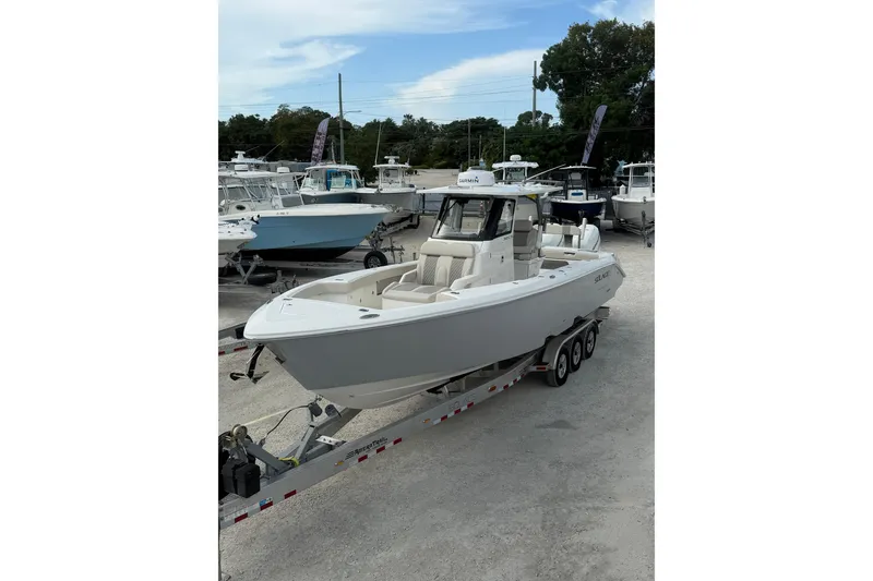  Yacht Photos Pics 2023 Solace 32 CS boat on trailer in marina setting.