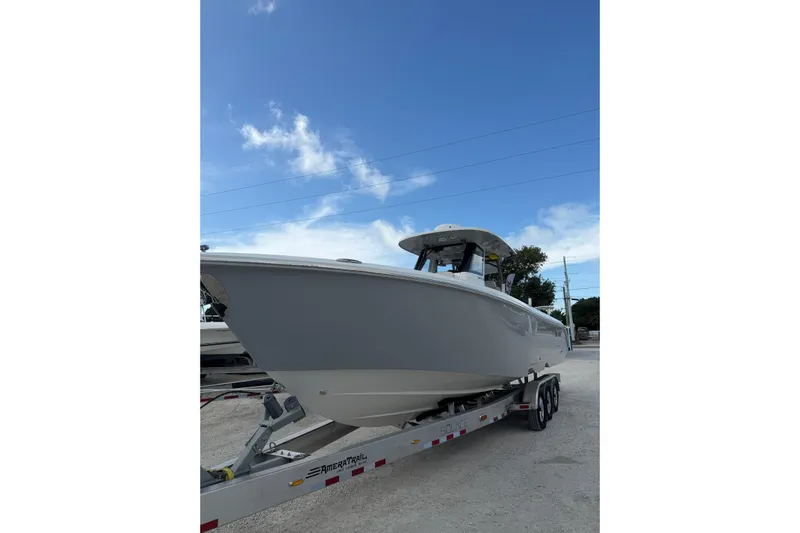  Yacht Photos Pics 2023 Solace 32 CS boat on trailer under clear blue sky.