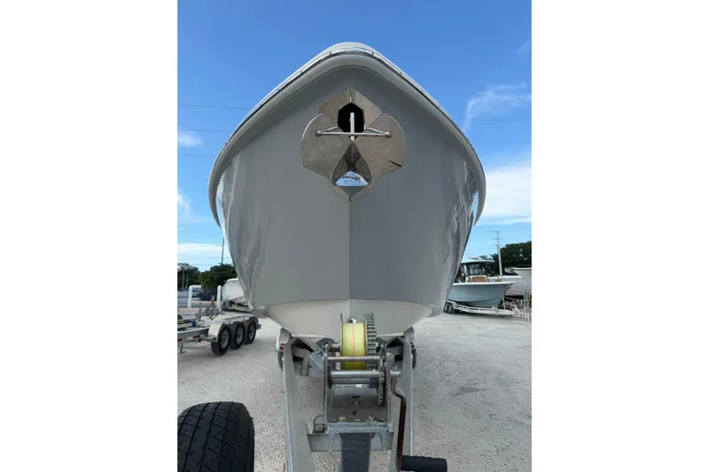  Yacht Photos Pics 2023 Solace 32 CS boat on trailer, viewed from the front under a clear blue sky.