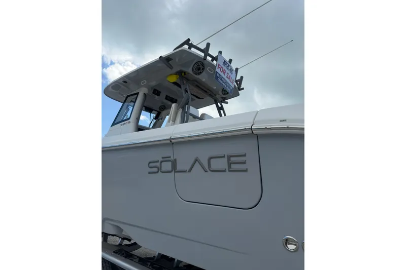  Yacht Photos Pics 2023 Solace 32 CS boat with "For Sale" sign, cloudy sky background.