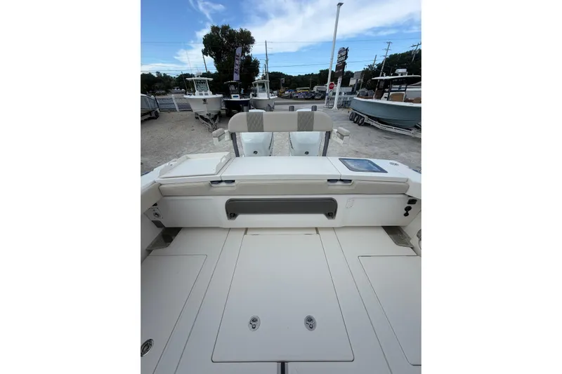  Yacht Photos Pics 2023 Solace 32 CS boat interior with seating and storage, displayed outdoors.