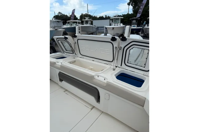  Yacht Photos Pics 2023 Solace 32 CS boat with open storage compartments and sleek design.