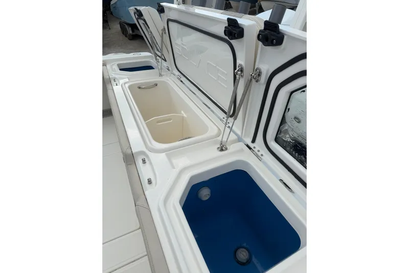  Yacht Photos Pics 2023 Solace 32 CS boat storage compartments with open lids, showcasing interior design.