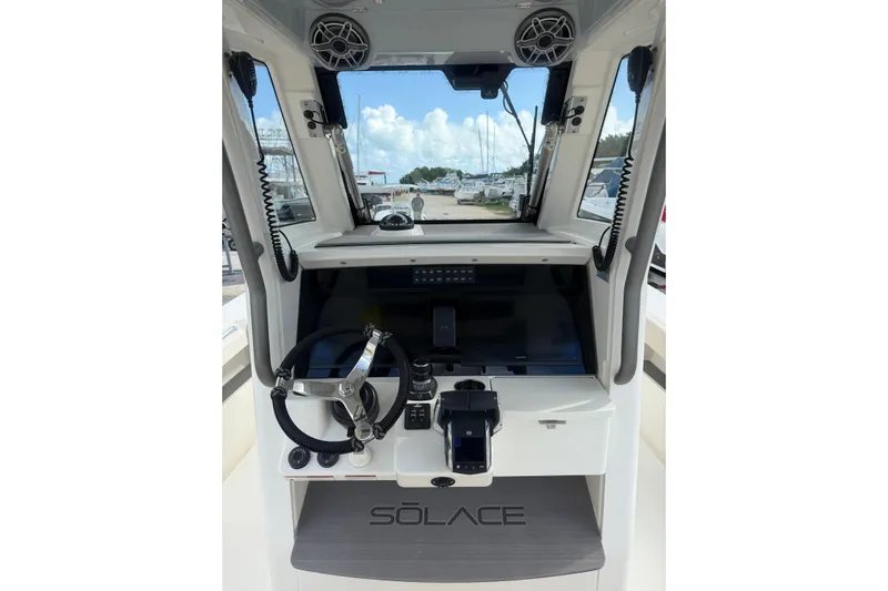  Yacht Photos Pics 2023 Solace 32 CS boat helm with steering wheel and control panel.
