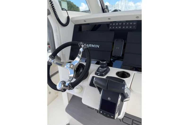 Yacht Photos Pics 2023 Solace 32 CS boat helm with Garmin navigation system and modern controls.