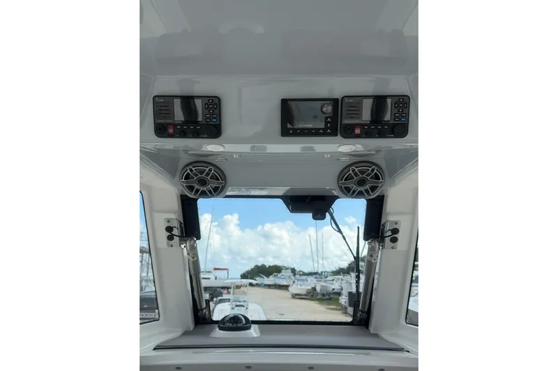  Yacht Photos Pics 2023 Solace 32 CS boat interior with electronic controls and speakers, marina view.