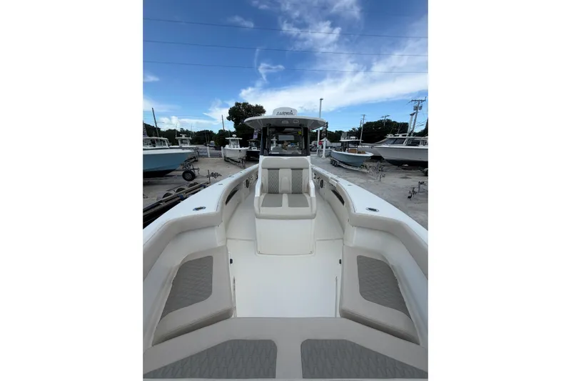  Yacht Photos Pics 2023 Solace 32 CS boat interior with seating, docked under a blue sky.