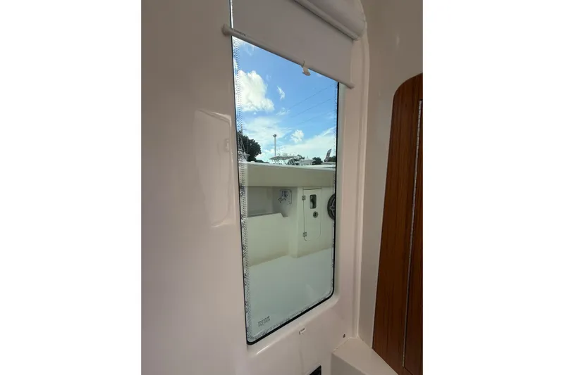  Yacht Photos Pics Window view from 2023 Solace 32 CS boat, showcasing exterior and blue sky.