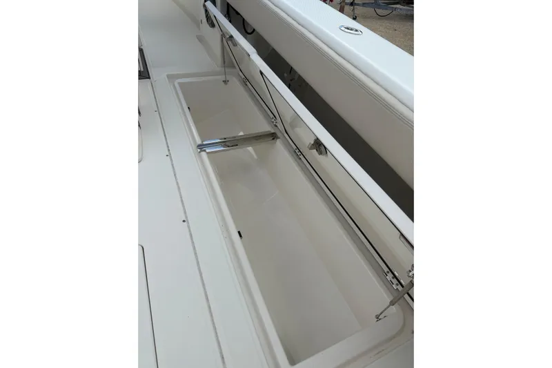  Yacht Photos Pics 2023 Solace 32 CS boat storage compartment with open lid, showcasing spacious interior.