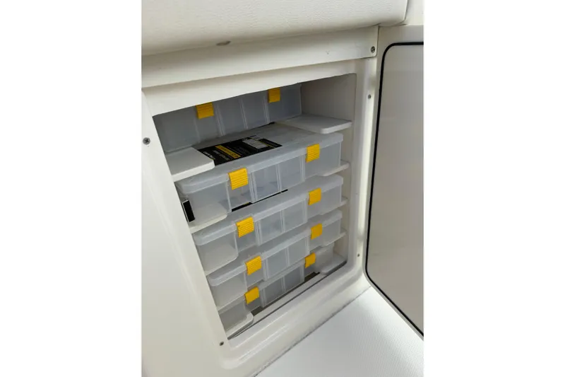  Yacht Photos Pics Storage compartment with organized tackle boxes in a 2023 Solace 32 CS boat.