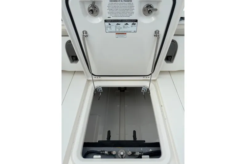  Yacht Photos Pics Open storage compartment on a 2023 Solace 32 CS boat, showcasing interior details.
