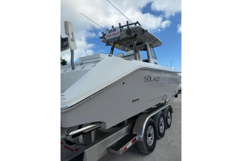  Yacht Photos Pics 2023 Solace 32 CS boat on trailer, for sale under clear sky.
