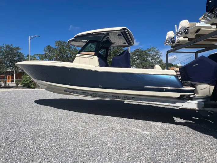  Yacht Photos Pics 2024 Chris-Craft Catalina 30 boat on a trailer under a clear blue sky.