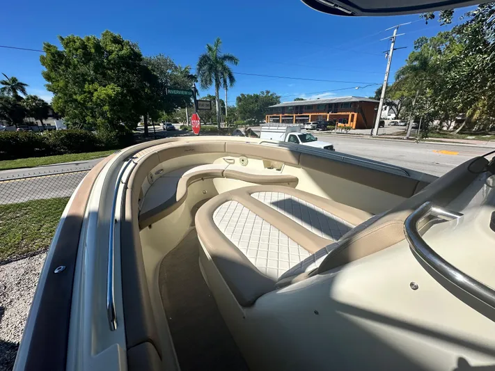  Yacht Photos Pics 2024 Chris-Craft Catalina 30 boat interior with cushioned seating, docked under clear blue sky.