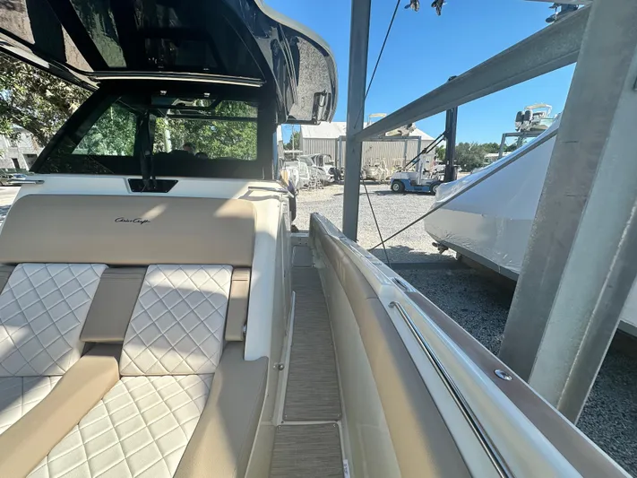  Yacht Photos Pics 2024 Chris-Craft Catalina 30 boat interior with beige and white diamond-stitched seating.