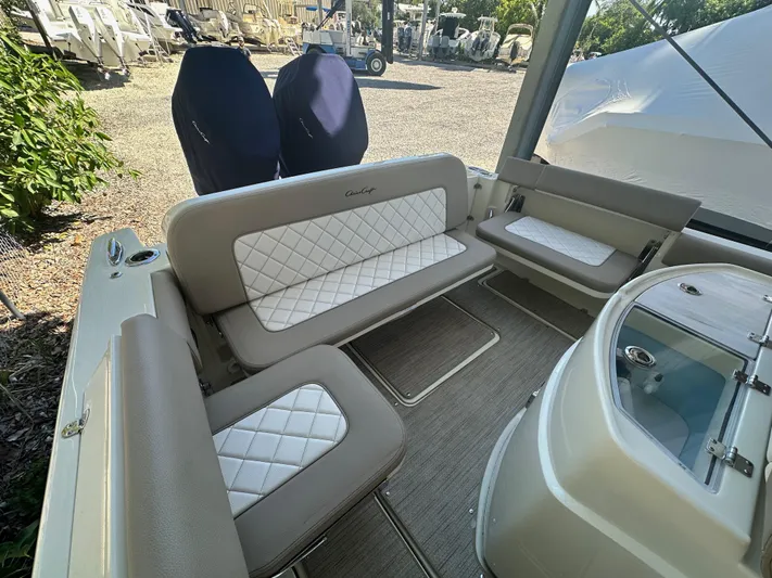  Yacht Photos Pics 2024 Chris-Craft Catalina 30 interior seating area with white and beige upholstery.