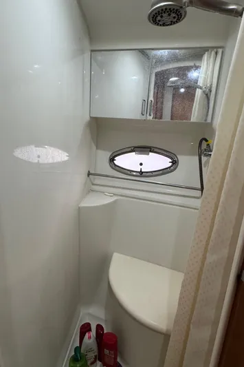  Yacht Photos Pics 2001 Carver 444 Cockpit Motor Yacht bathroom with shower and porthole window.