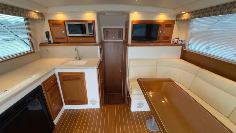 A-plus Yacht Photos Pics Interior of 2003 Cabo 35 Flybridge Sportfisher with kitchen and seating area.