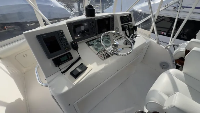 A-plus Yacht Photos Pics 2003 Cabo 35 Flybridge Sportfisher helm with navigation equipment and steering wheel.