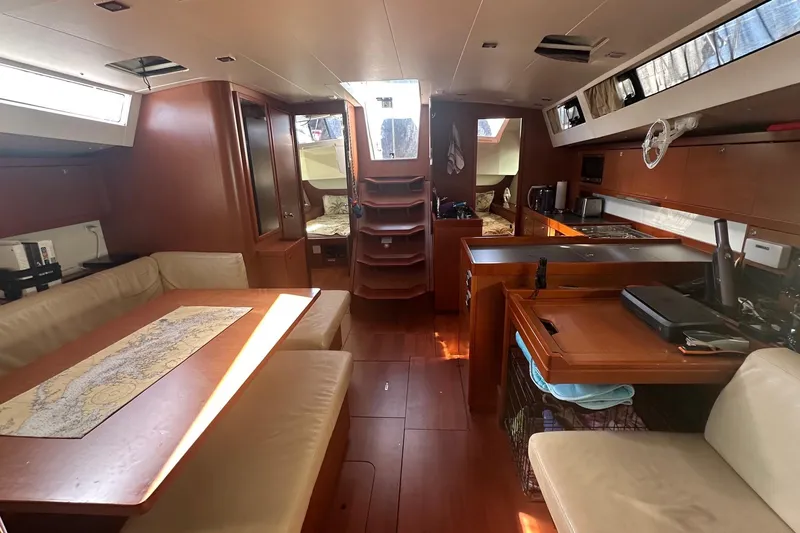  Yacht Photos Pics Interior of a 2014 Beneteau Oceanis 48 yacht, featuring a spacious dining and kitchen area.