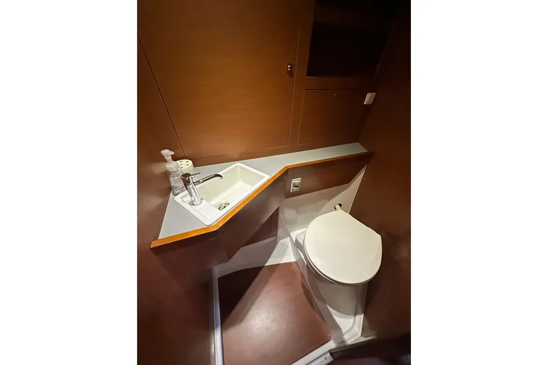  Yacht Photos Pics Bathroom interior of 2014 Beneteau Oceanis 48 yacht, featuring sink and toilet.