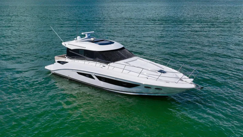 Just In Time Yacht Photos Pics 2016 Sea Ray 470 Sundancer yacht cruising on clear blue water.