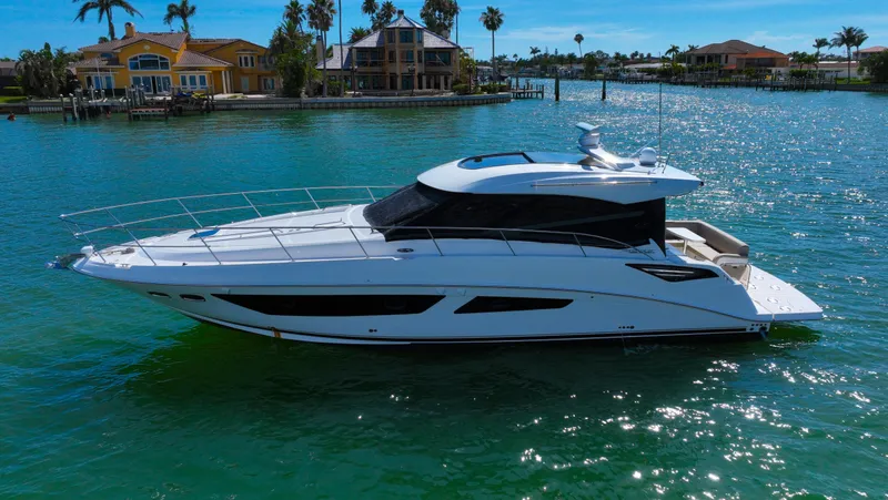 Just In Time Yacht Photos Pics 2016 Sea Ray 470 Sundancer yacht cruising on a sunny day near waterfront homes.