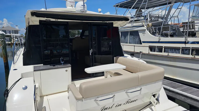 Just In Time Yacht Photos Pics 2016 Sea Ray 470 Sundancer yacht docked, featuring a spacious rear seating area.