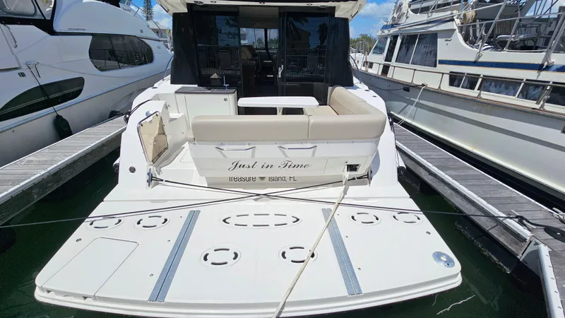 Just In Time Yacht Photos Pics 2016 Sea Ray 470 Sundancer yacht docked, rear view with seating and swim platform.