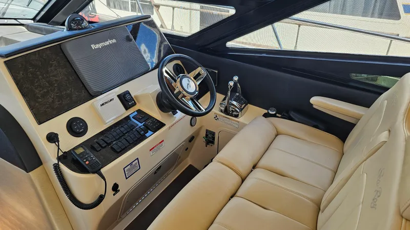 Just In Time Yacht Photos Pics 2016 Sea Ray 470 Sundancer helm with beige leather seating and advanced navigation controls.