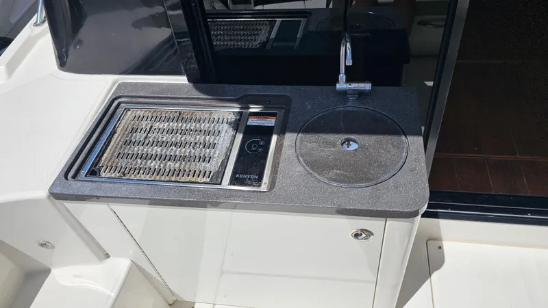 Just In Time Yacht Photos Pics Outdoor kitchenette on 2016 Sea Ray 470 Sundancer yacht with grill and sink.