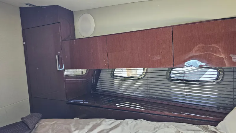 Just In Time Yacht Photos Pics Interior cabin of 2016 Sea Ray 470 Sundancer yacht with wood cabinetry and windows.