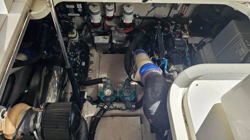 Just In Time Yacht Photos Pics Engine room of 2016 Sea Ray 470 Sundancer yacht, showcasing mechanical components.