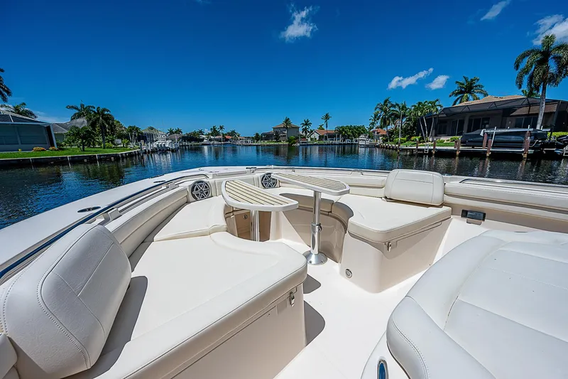 Yacht Photos Pics 2019 Grady-White Canyon 456 boat with luxurious seating on a sunny waterfront.