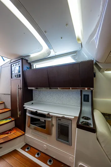  Yacht Photos Pics 2019 Grady-White Canyon 456 interior kitchen area with modern appliances and wooden cabinetry.