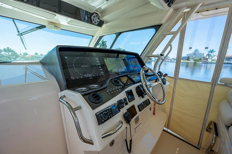  Yacht Photos Pics 2019 Grady-White Canyon 456 helm station with advanced navigation system and waterfront view.