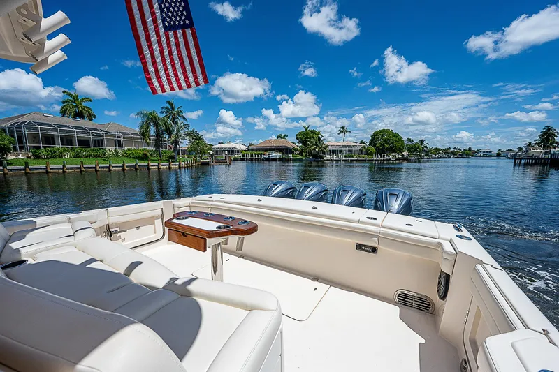  Yacht Photos Pics 2019 Grady-White Canyon 456 boat on a sunny day with American flag.