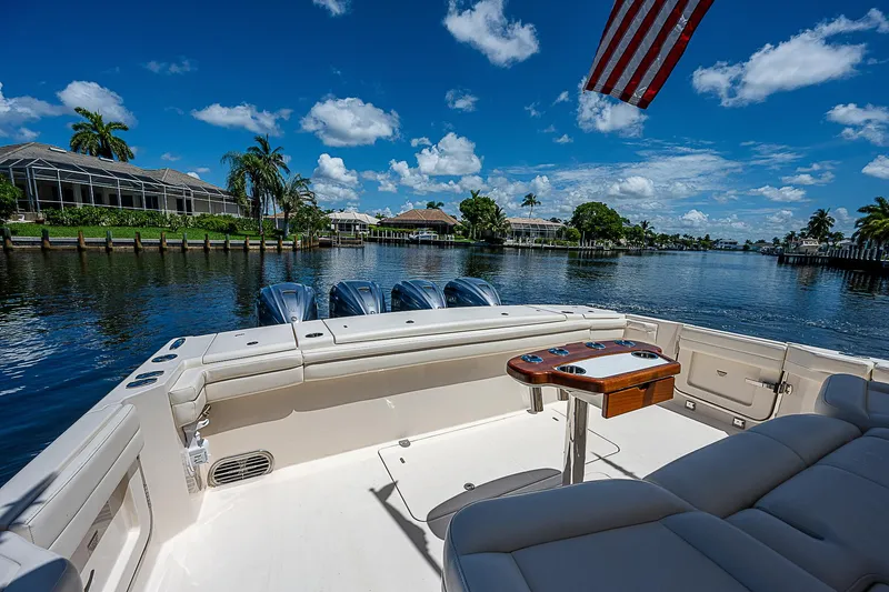  Yacht Photos Pics 2019 Grady-White Canyon 456 boat on a scenic waterfront with clear skies.