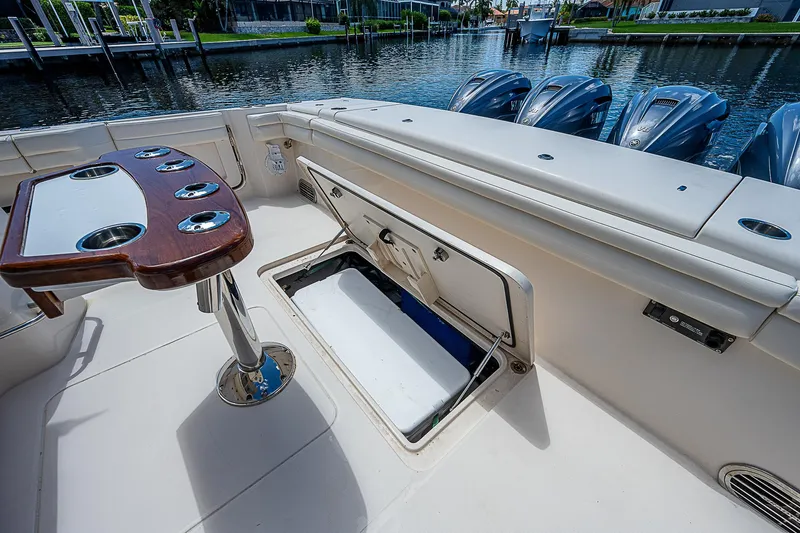  Yacht Photos Pics 2019 Grady-White Canyon 456 boat interior with open storage compartment and fishing rod holders.