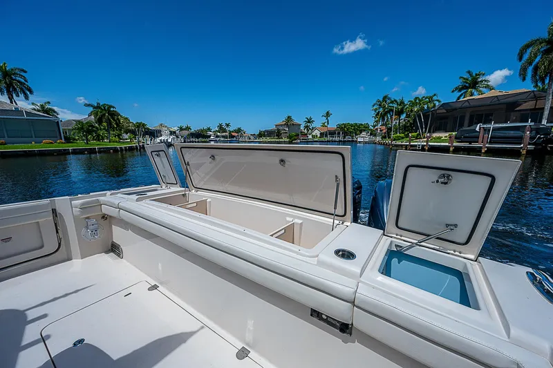  Yacht Photos Pics 2019 Grady-White Canyon 456 boat with open storage compartments on a sunny day.