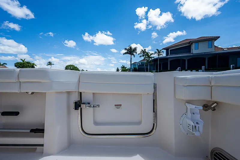  Yacht Photos Pics 2019 Grady-White Canyon 456 boat interior with blue sky and waterfront home background.