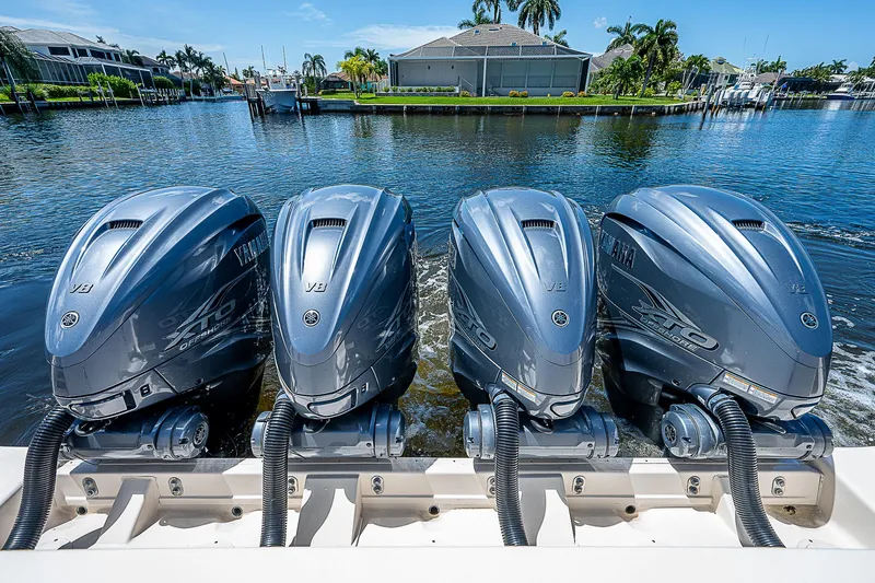  Yacht Photos Pics 2019 Grady-White Canyon 456 with four Yamaha outboard engines on a sunny day.