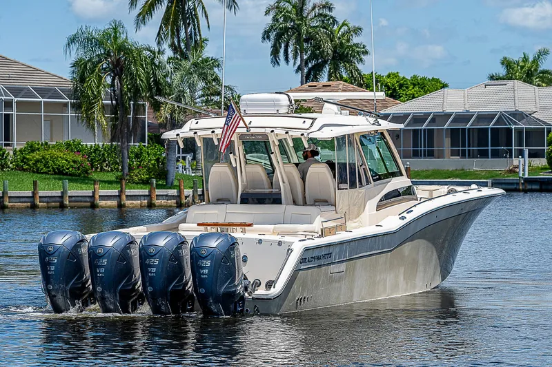  Yacht Photos Pics 2019 Grady-White Canyon 456 boat with four outboard engines on a sunny day.