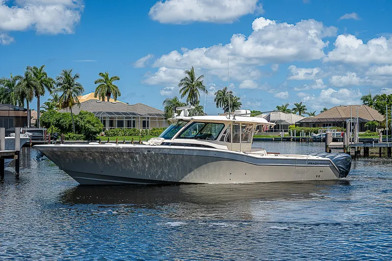  Yacht Photos Pics 2019 Grady-White Canyon 456 boat on a sunny day in a marina.
