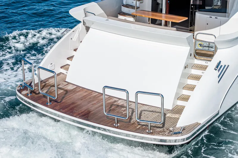  Yacht Photos Pics Sleek 2023 Massimo Marine 72' Flybridge Motor Yacht with elegant teak swim platform.