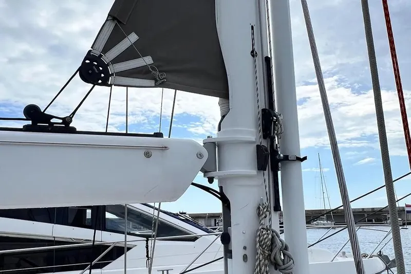  Yacht Photos Pics Sailboat mast and rigging on a 2016 Amel 64 yacht under a cloudy sky.