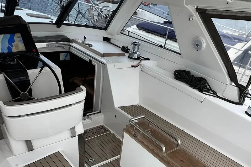  Yacht Photos Pics Interior view of a 2016 Amel 64 yacht cockpit with steering wheel and seating.