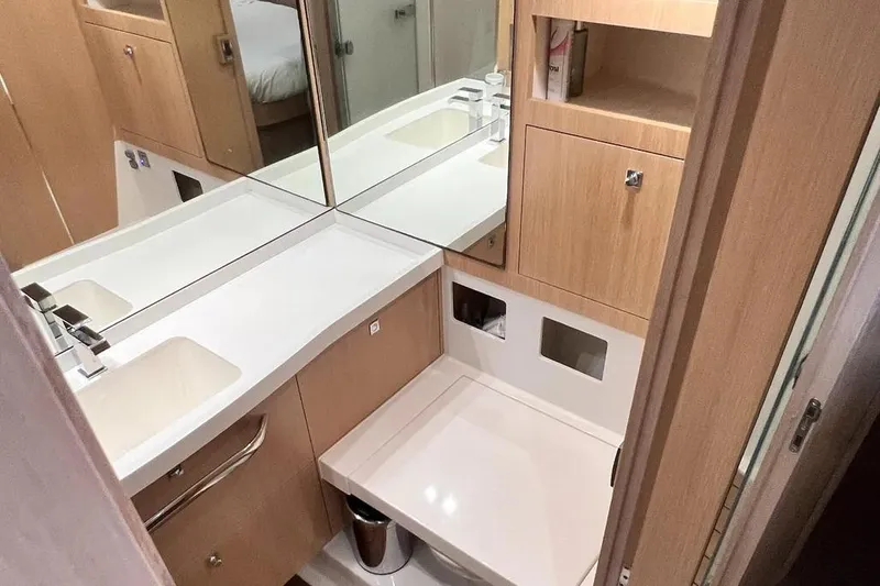  Yacht Photos Pics Modern bathroom in 2016 Amel 64 yacht with sleek fixtures and wooden cabinetry.
